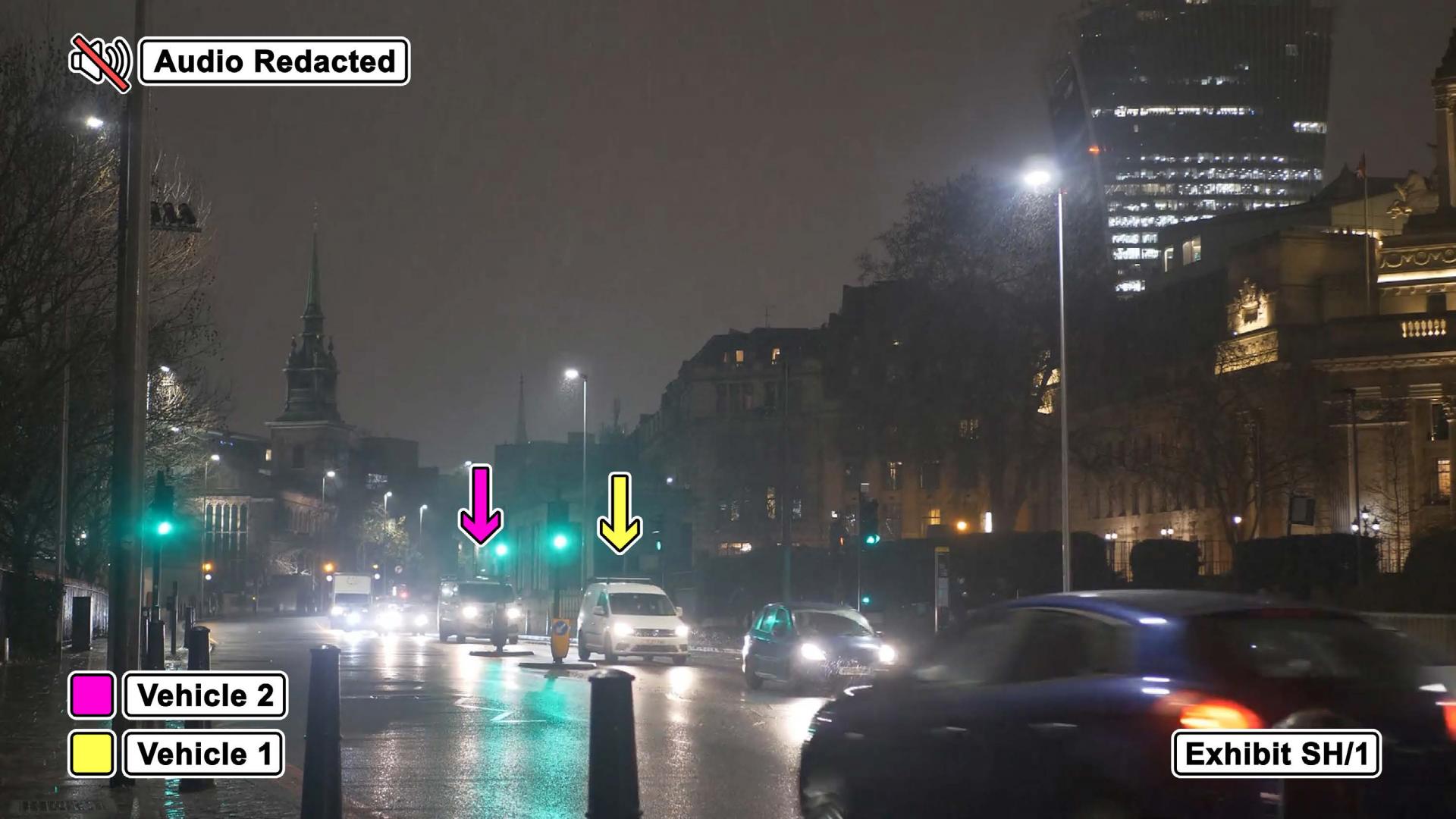 Image of road at nighttime showing two cars